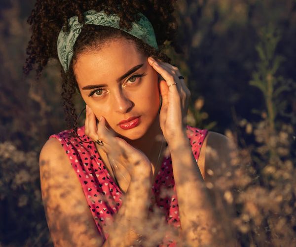 Person stretching gracefully outdoors with a sunset background.